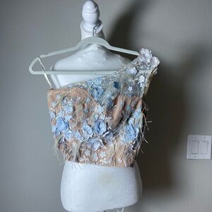 One shoulder blouse from a Colombian designer with feathers.